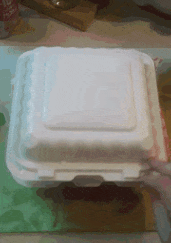 a styrofoam container with a lid that says ' tc ' on it