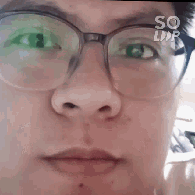 a close up of a person 's face with glasses and the word so on the bottom left