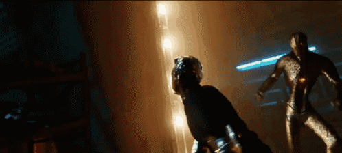 a man and a woman are fighting in a dark room with lights behind them