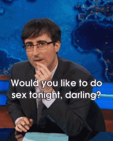 a man in a suit and glasses is sitting at a desk with the words would you like to do sex tonight darling