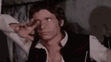 han solo from star wars is making a peace sign with his hands .