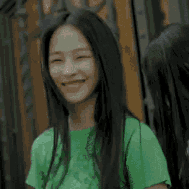 a blue smiley face is behind a person 's face