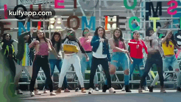 a group of young women are dancing in front of a sign that says `` i am a superstar '' .