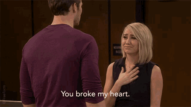a man and woman are standing next to each other and the man says you broke my heart