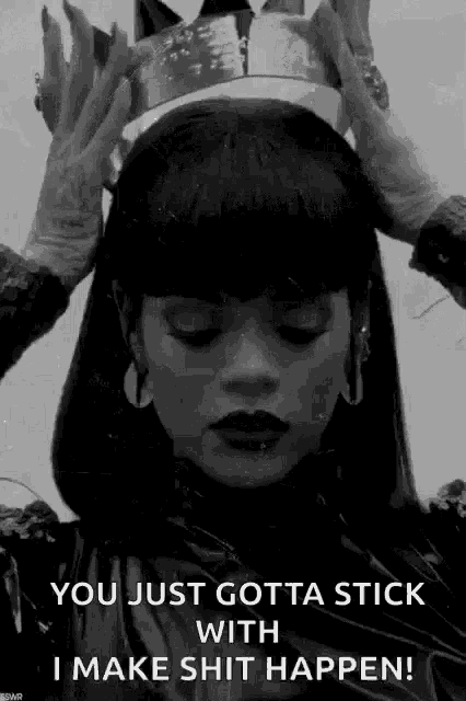 a black and white photo of a woman wearing a crown on her head