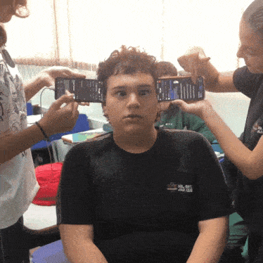 a boy wearing a black shirt that says ' aoc ' on it