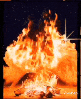 a large fire is burning in the dark with a star in the background .