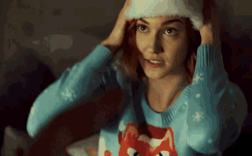 a woman wearing a sweater with a fox on it