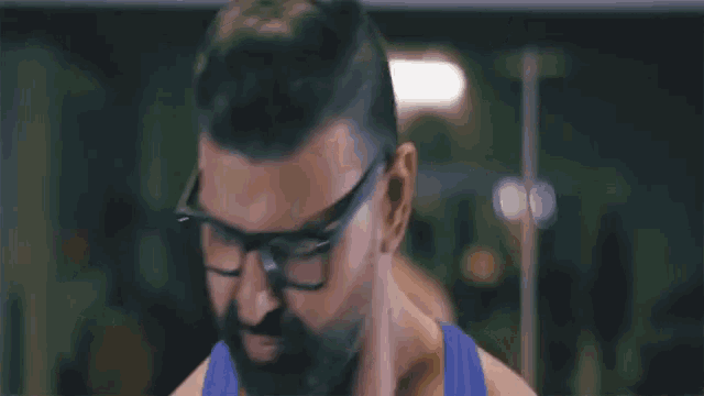 a man with a beard and glasses making a funny face
