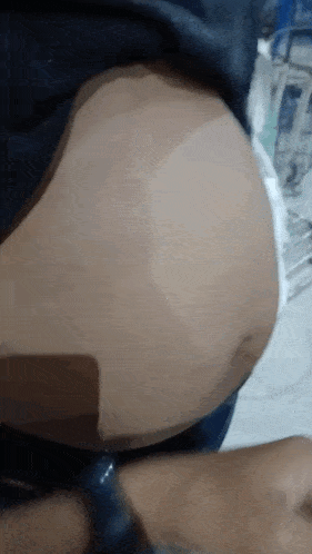 a close up of a person 's stomach with a black shirt on