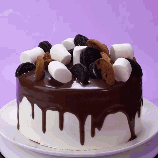 a cake with oreos and marshmallows on top of it