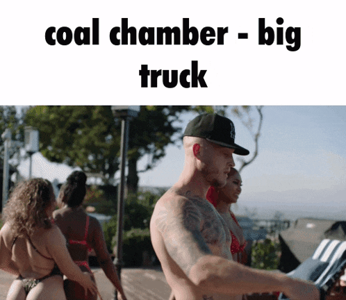 a man without a shirt is standing in front of a group of women with the words coal chamber - big truck above him