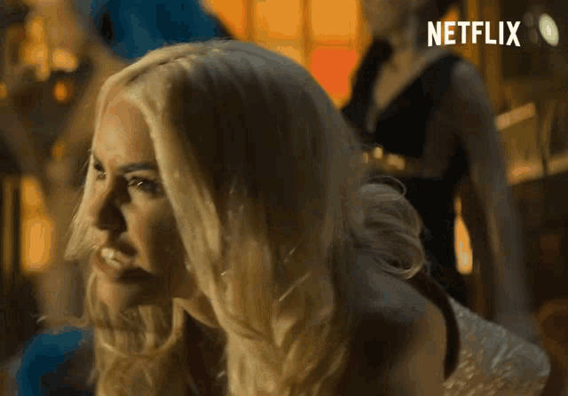 a blonde woman is smiling in a netflix ad