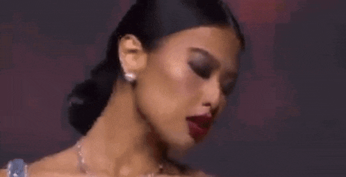a close up of a woman 's face with her eyes closed and red lipstick .