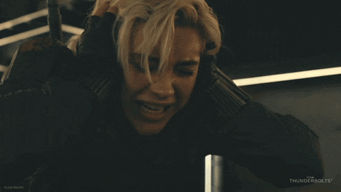 a woman in a black jacket with thunderbolts on the bottom