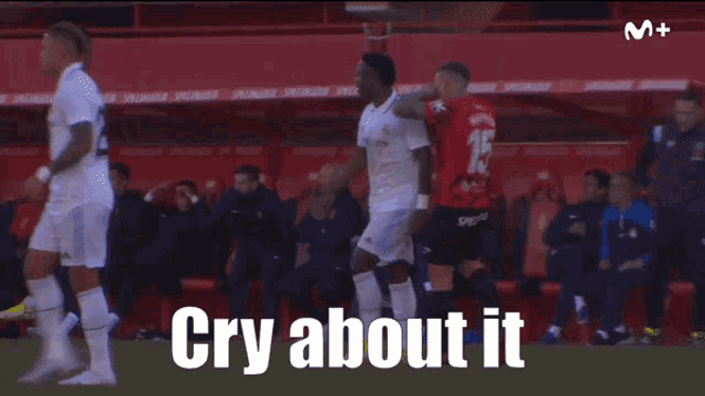 a soccer player wearing a fly emirates shirt is running on a field