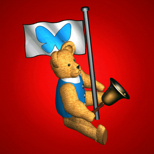 a teddy bear holding a bell and a flag with a butterfly on it