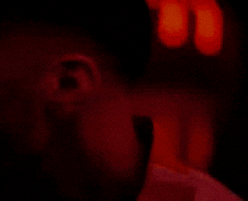 a close up of a man 's face with his mouth open and teeth showing