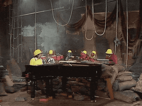 a group of people wearing hard hats are playing instruments