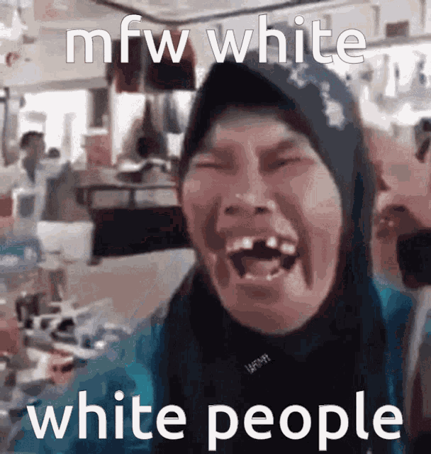 a woman in a hijab is laughing with a caption that says mfw white white people .