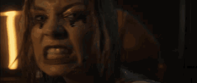 a close up of a woman 's face with blood on it