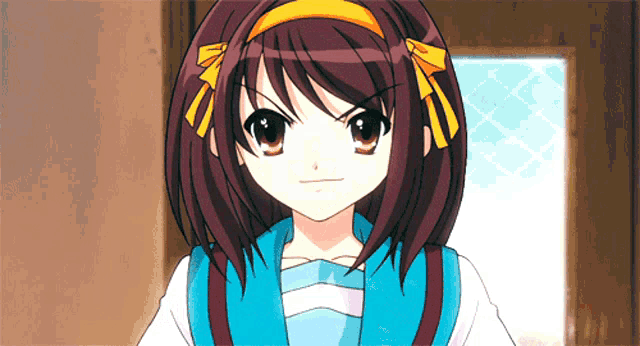 a girl with brown hair and a yellow bow on her head