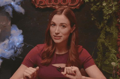 a woman says shocking in front of a sign that reads blood