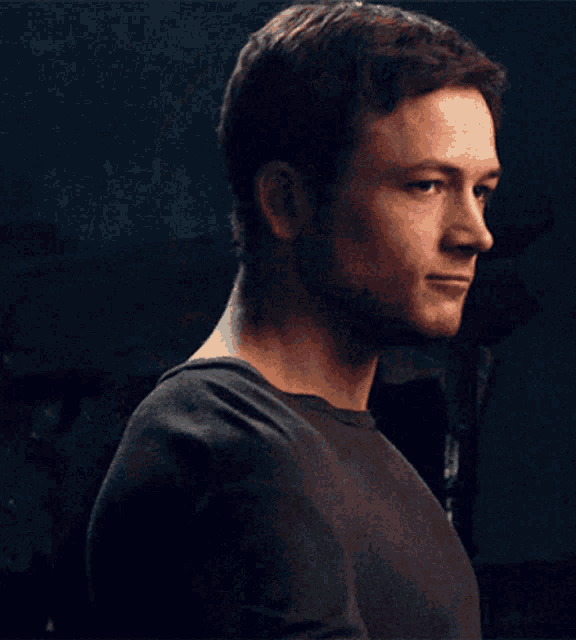 a close up of a man 's face with a black shirt on