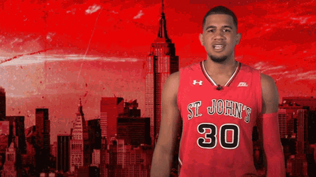 a man wearing a red st. john 's jersey with the number 30 on it