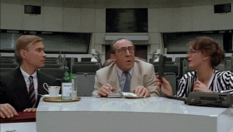a man in a suit and tie sits at a table with a woman