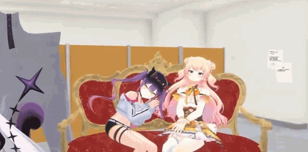 a couple of anime girls are sitting on a couch .