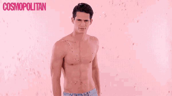 a shirtless man is standing in front of a pink background with confetti falling on him