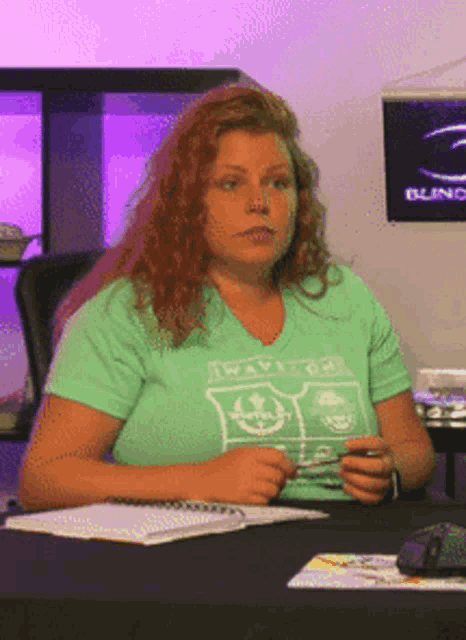a woman wearing a green t-shirt that says wave on it
