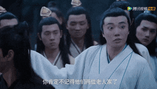 a man in a white robe stands in front of a crowd