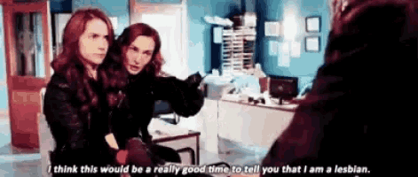 two women are sitting next to each other in a room and one of them is talking to another woman .