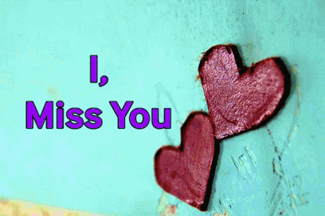 two purple hearts on a green background with the words i miss you