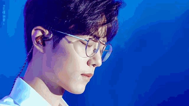 a close up of a person wearing glasses and earphones