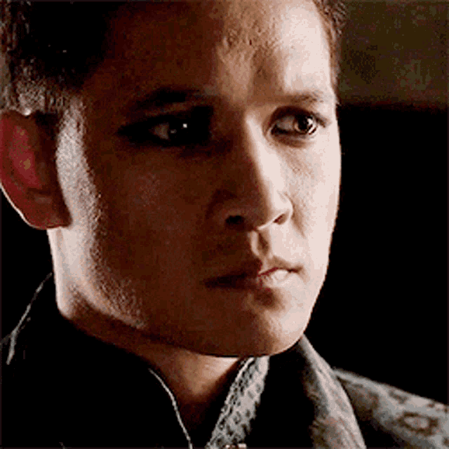 a close up of a man 's face with a serious look on his face