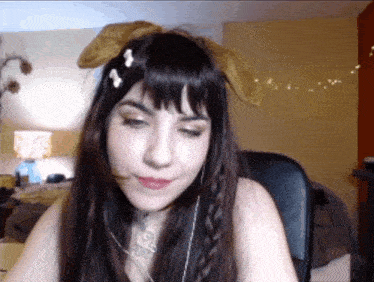 a woman wearing bunny ears and a braided hair style