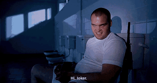 a man sitting on a toilet with the words hi joker written below him