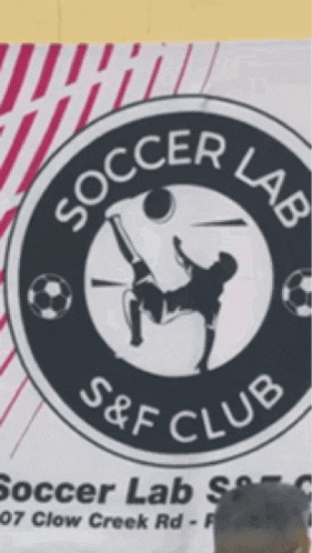 a man stands in front of a sign for soccer lab