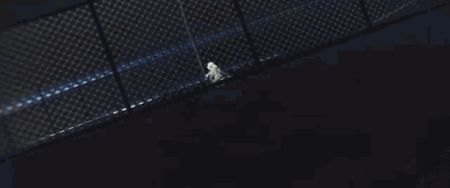 a person is walking down a set of stairs in a dark room with a blue background .