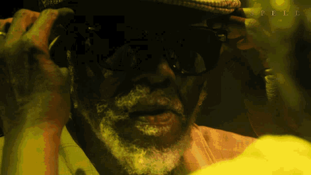 a close up of a man 's face with spell written on the bottom right