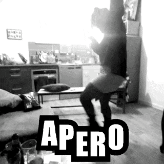 a black and white photo of a person dancing in a living room with the word apero in the corner