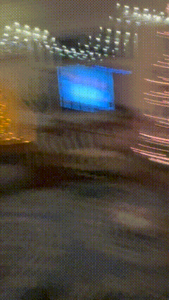 a blurry picture of a building with a blue sign in the middle