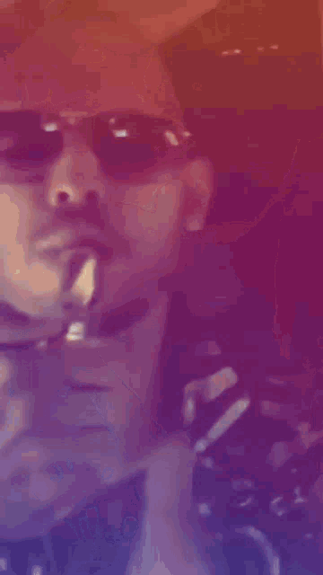 a close up of a person 's face with sunglasses on