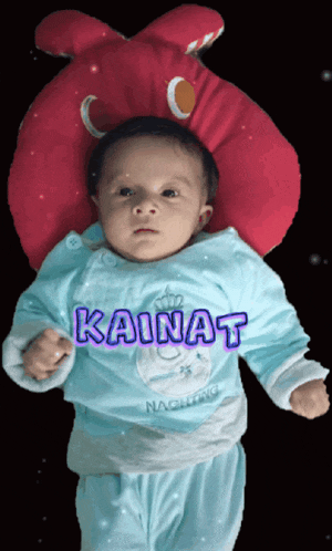 a baby wearing a blue shirt with the name kainat on it