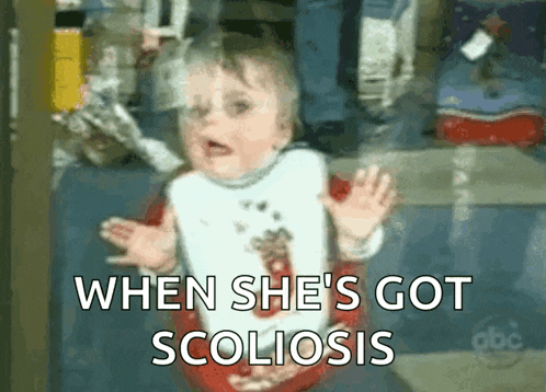 a baby is wearing a bib and says when she 's got scoliosis .