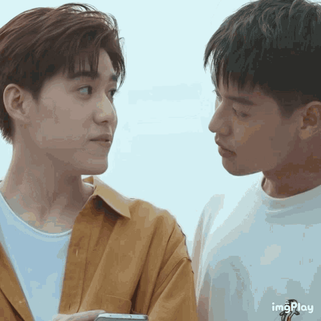 two young men looking at each other with a gif that says imgplay on the bottom