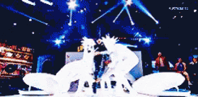 a group of people are dancing on a stage with a sign that says ' apollo 12 ' on it